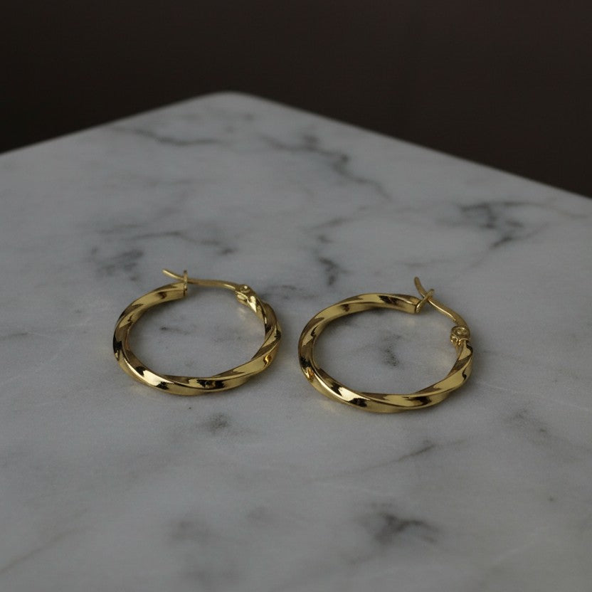 SVORA gold twisted hoop earrings with a polished finish and rounded silhouette, made of stainless steel.