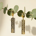 SVORA gold-tone stainless steel huggie hoop earrings with Greek key cut-out drop and pavé cubic zirconia.