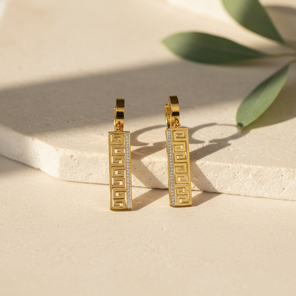 SVORA gold-tone stainless steel drop earrings with Greek key cut-out and pavé cubic zirconia detail.