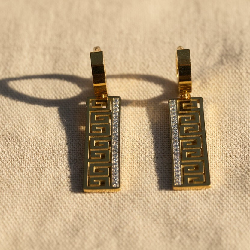SVORA gold-tone stainless steel drop earrings with Greek key cut-out and pavé cubic zirconia detail.