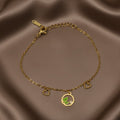 SVORA gold chain bracelet with green leaf, heart charms, and cubic zirconia stone. Adjustable.