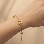 SVORA gold chain bracelet with green leaf charm and cubic zirconia accent. Adjustable, lobster clasp.