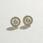 SVORA gold tone stainless steel stud earrings with round cubic zirconia center and pavé halo.