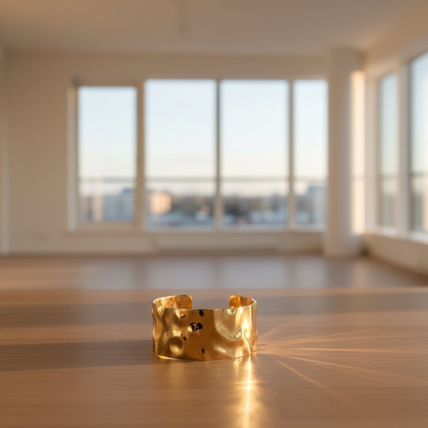 SVORA wide hammered gold cuff bracelet made of 18K gold plated stainless steel. Adjustable and waterproof.