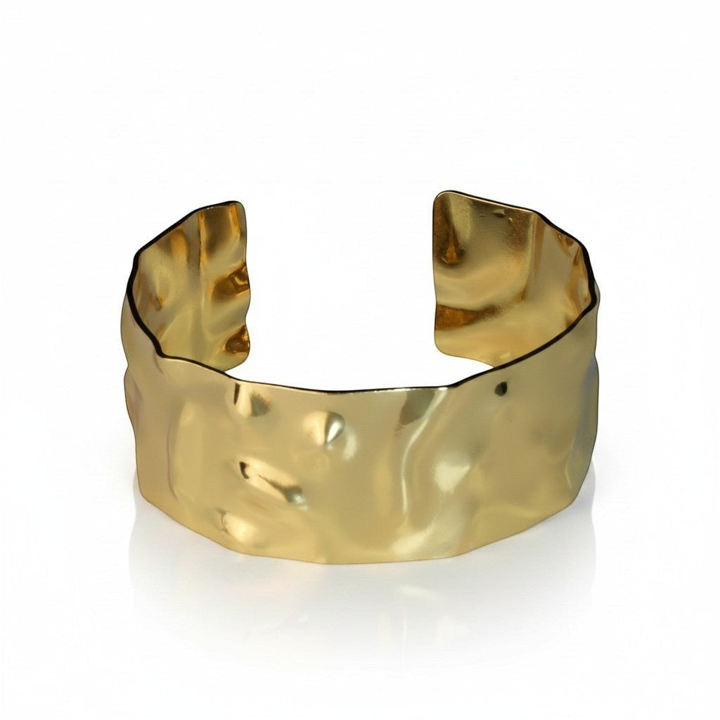 SVORA wide hammered gold cuff bracelet made of 18K gold plated stainless steel. Adjustable and waterproof.