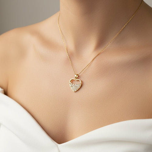 SVORA gold plated stainless steel half heart pendant necklace with baguette CZ stones.