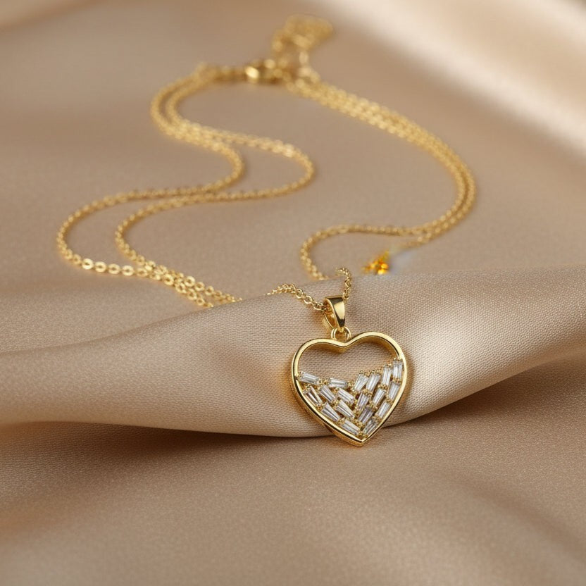 SVORA gold plated stainless steel necklace with a heart pendant filled with baguette-cut cubic zirconia stones.