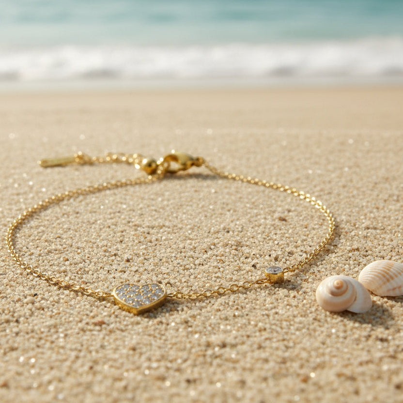 SVORA gold plated stainless steel bracelet with CZ pavé heart charm and round stone accent on a fine cable chain.