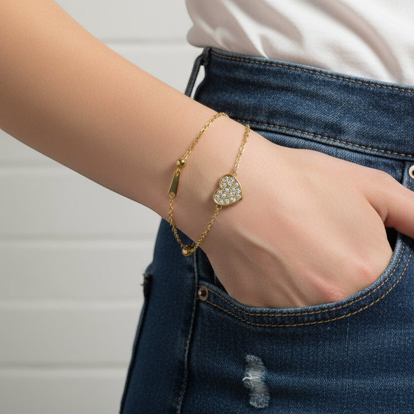 SVORA gold plated stainless steel bracelet with a CZ pavé heart charm and adjustable slider.