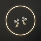 SVORA gold tone stainless steel stud earrings with pavé heart petals and leaf accents, adorned with cubic zirconia.