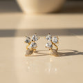 SVORA gold-tone stainless steel stud earrings with pavé heart petals and leaf accents, adorned with cubic zirconia.