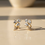SVORA gold-tone stainless steel stud earrings with pavé heart petals and leaf accents, adorned with cubic zirconia.