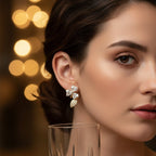 SVORA gold-tone stainless steel stud earrings with pavé cubic zirconia heart petals and a leaf accent.