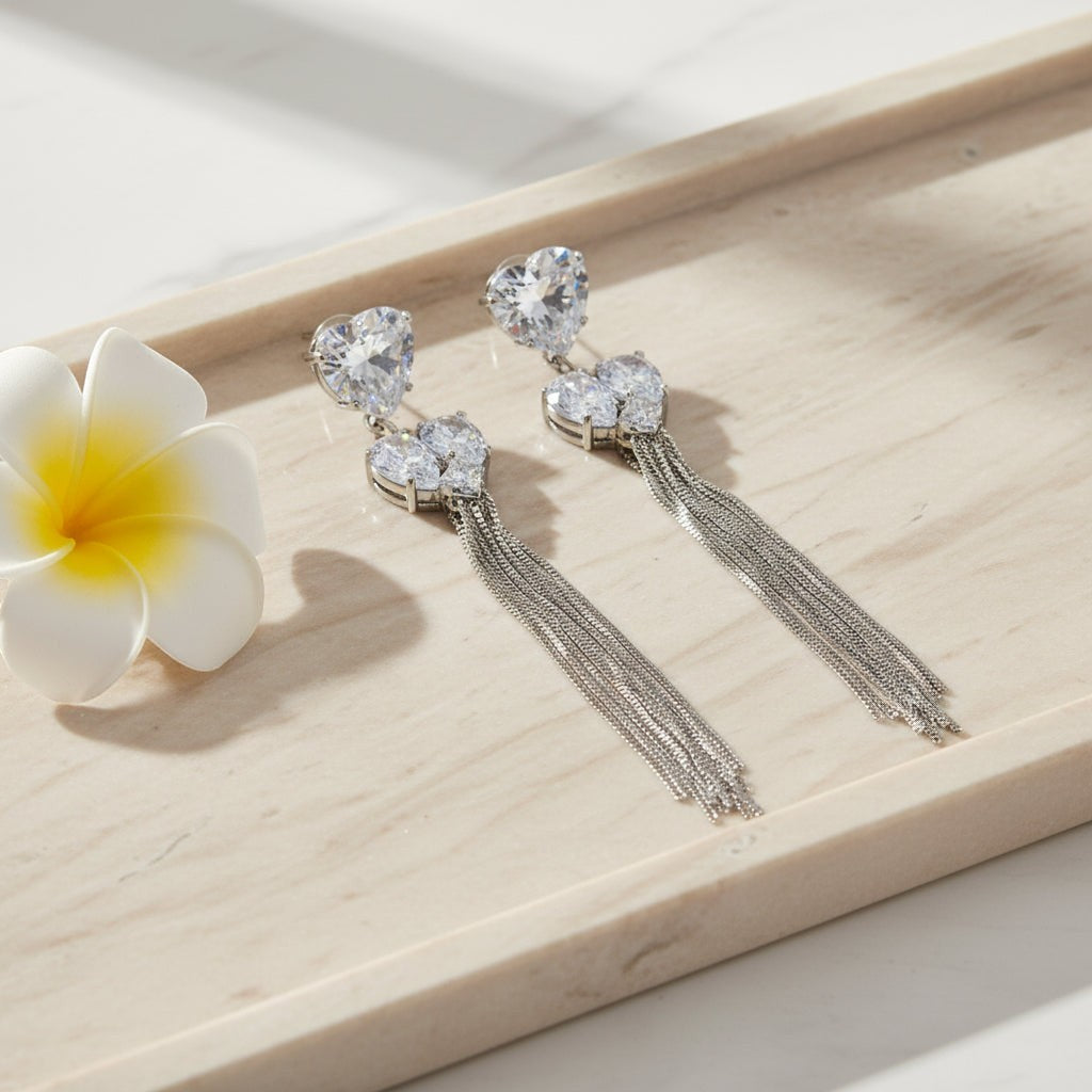 SVORA silver-tone dangle earrings with heart-shaped cubic zirconia clusters and five snake chains.