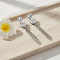 SVORA silver-tone dangle earrings with heart-shaped cubic zirconia clusters and five snake chains.