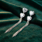 SVORA silver-tone dangle earrings with heart-shaped cubic zirconia clusters and snake chain tassels.