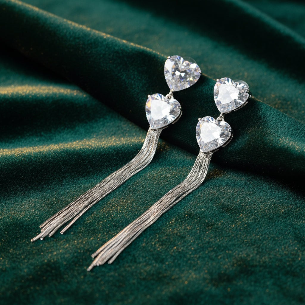 SVORA silver-tone dangle earrings with heart-shaped cubic zirconia clusters and snake chain tassels.