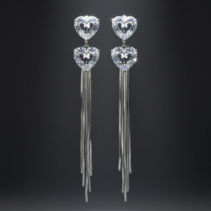 SVORA silver-tone dangle earrings with heart-shaped cubic zirconia and snake chain tassels.