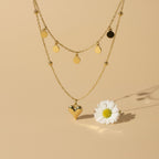 SVORA gold stainless steel layered necklace with heart and disc charms, tarnish-resistant and waterproof.