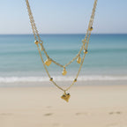 SVORA gold layered necklace with heart and disc charms, made of stainless steel with 18k gold plating.