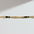 SVORA gold-plated stainless steel bracelet with a delicate chain of small, linked hearts. Adjustable with lobster clasp.