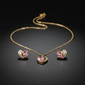 SVORA gold tone necklace and earrings set with pink pear-cut crystal and cubic zirconia heart pendants.