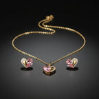 SVORA gold tone necklace and earrings set with pink pear-cut crystal and cubic zirconia heart pendants.