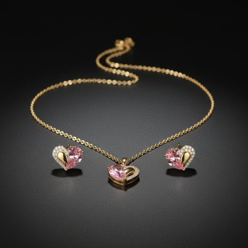 SVORA gold tone necklace and earrings set with pink pear-cut crystal and cubic zirconia heart pendants.