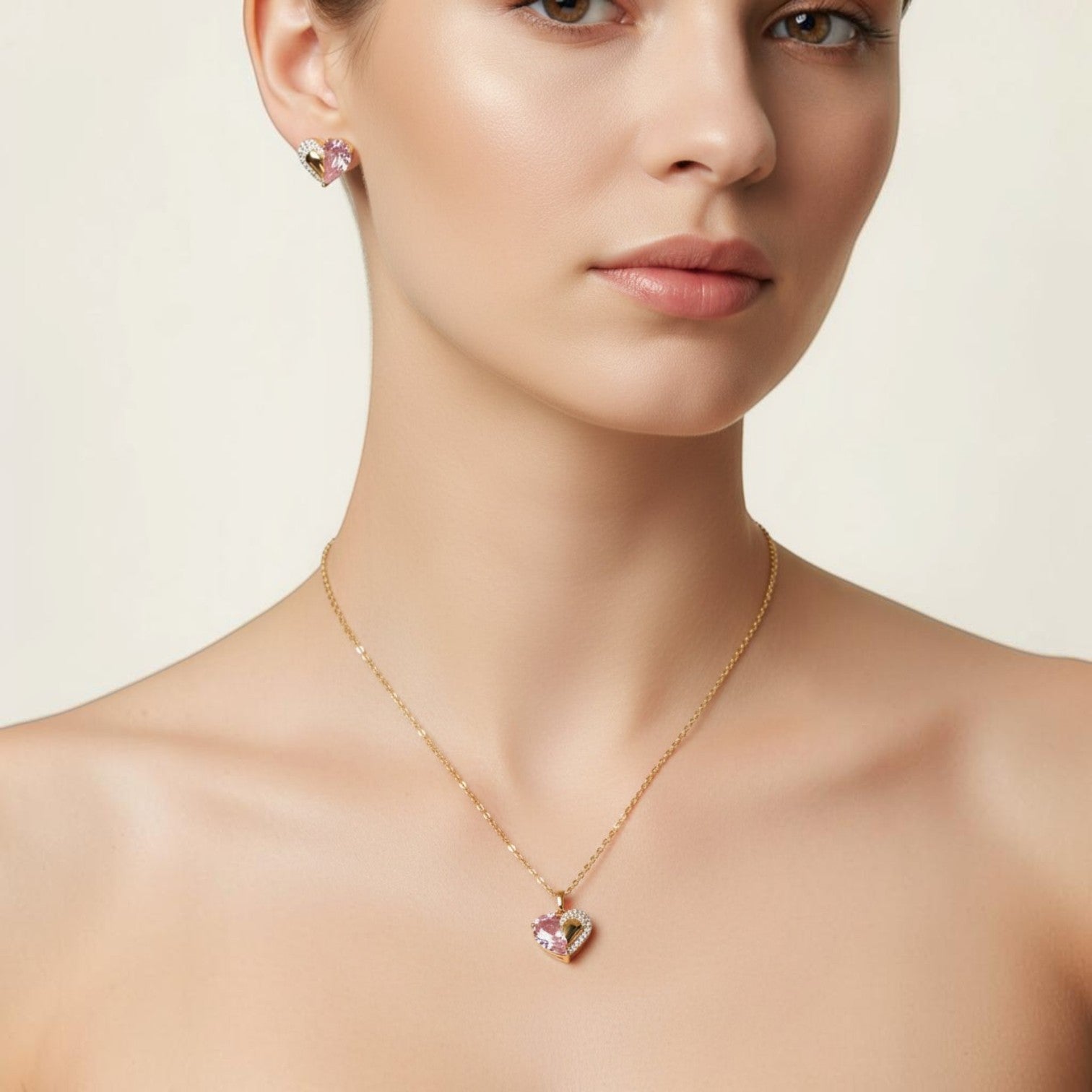 SVORA gold tone necklace and earrings set with pink crystal and cubic zirconia heart pendants.