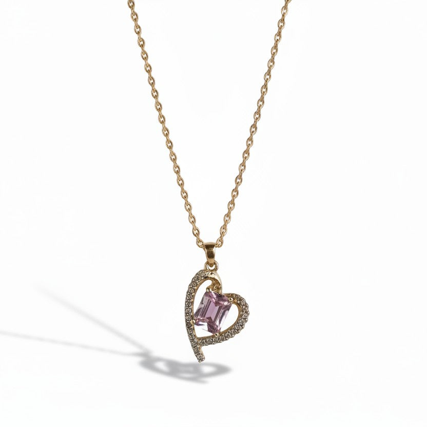 SVORA gold-plated stainless steel necklace with a heart-shaped pendant featuring a pink rectangular gemstone and clear accent stones.