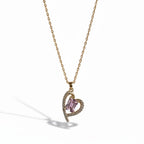 SVORA gold-plated stainless steel necklace with a heart-shaped pendant featuring a pink rectangular gemstone and clear accent stones.