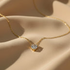 SVORA gold-plated stainless steel necklace with a clear heart-cut cubic zirconia solitaire pendant.