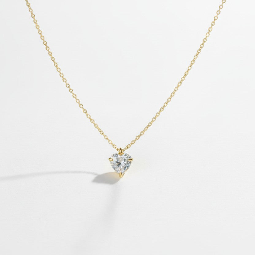 SVORA gold plated stainless steel necklace with a clear heart-cut cubic zirconia solitaire pendant.