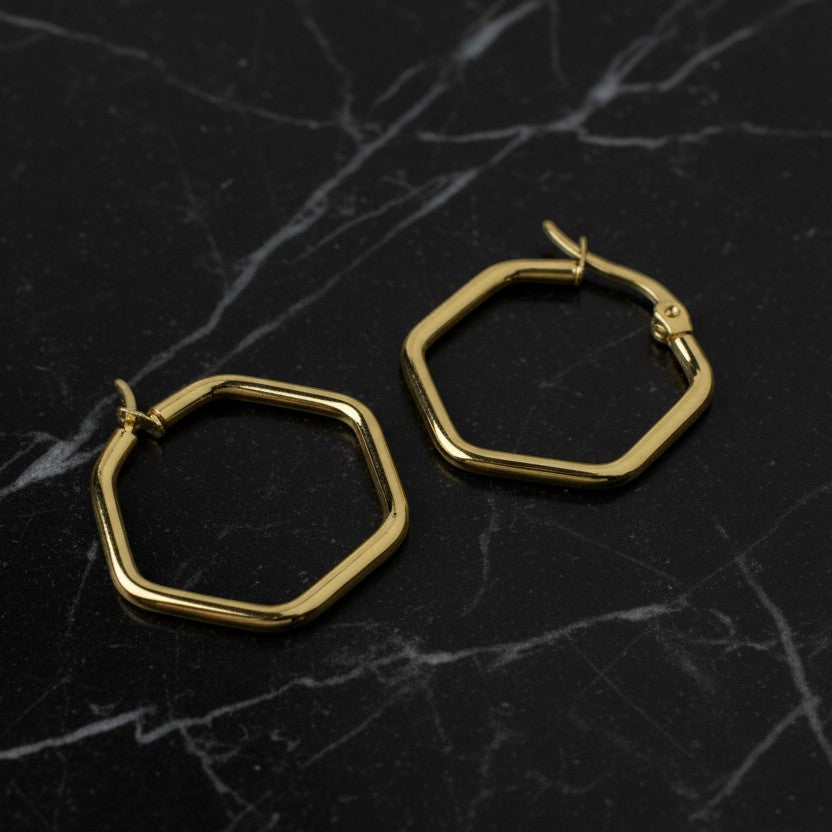 SVORA gold-tone stainless steel hexagon hoop earrings with a polished finish.