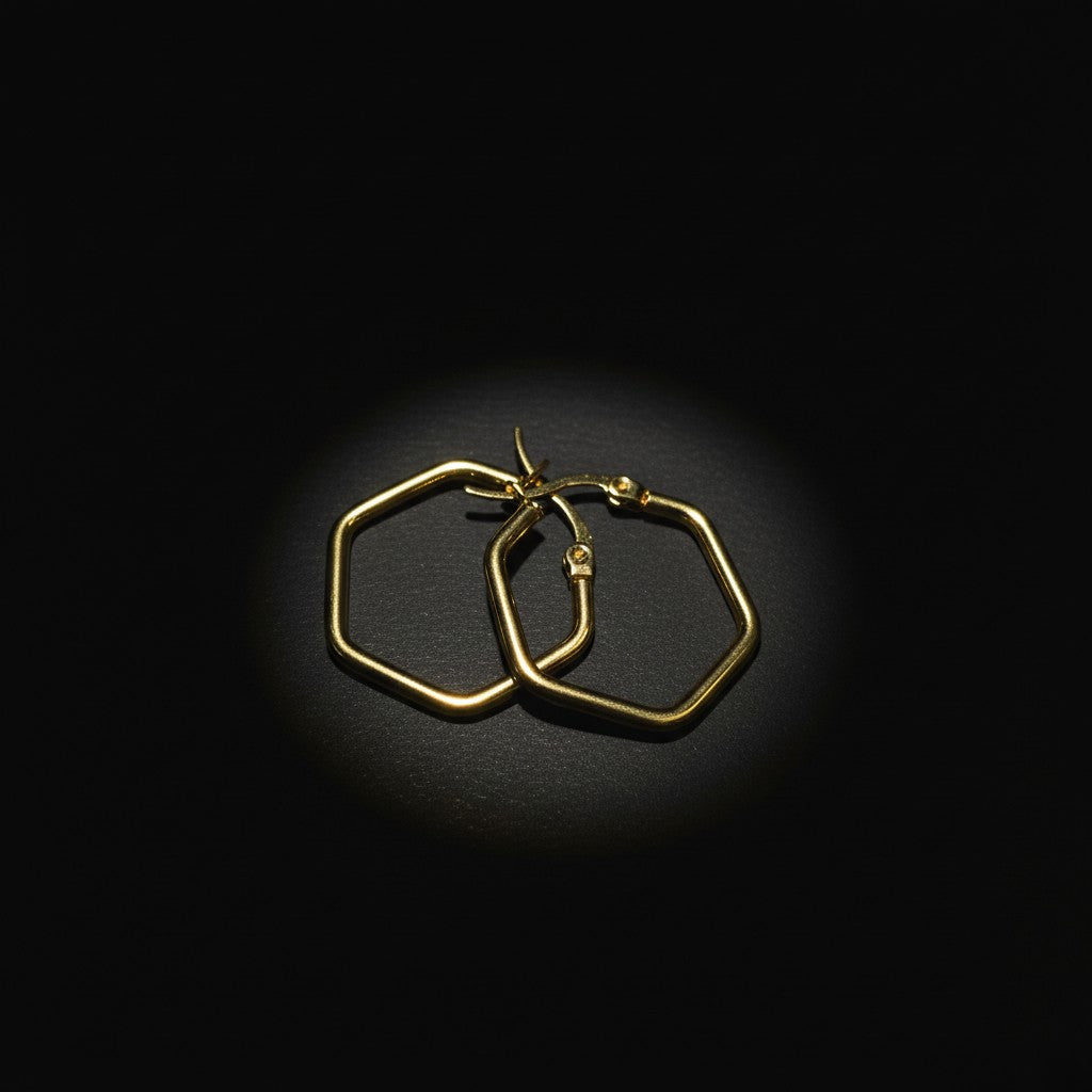SVORA gold-tone stainless steel hexagon hoop earrings with a polished finish. Modern, minimal, and elegant design.