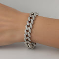 SVORA iced Cuban link bracelet with white CZ stones on a wrist. Silver-tone, rhodium plated stainless steel.