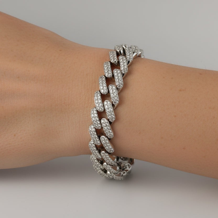 SVORA iced Cuban link bracelet with white CZ stones on a wrist. Silver-tone, rhodium plated stainless steel.