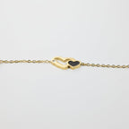 SVORA gold plated stainless steel bracelet with interlocking hearts, one black, one with a CZ stone.