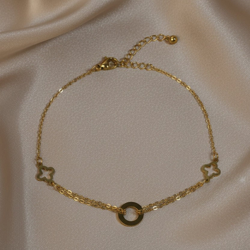 SVORA gold layered chain bracelet with hollow circle and clover charms. Adjustable, lobster clasp, 18K gold plated stainless steel.
