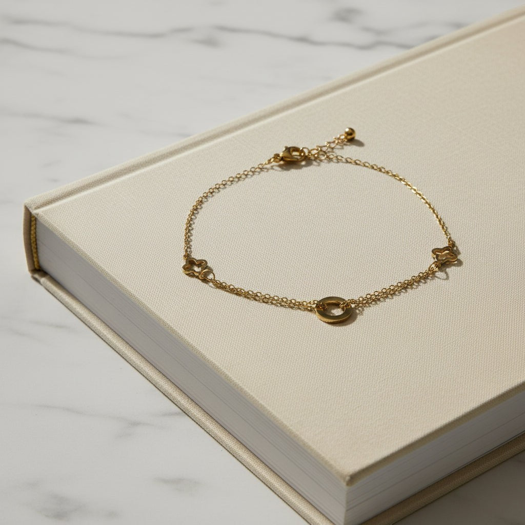 SVORA gold layered chain bracelet with hollow circle and clover charms. Adjustable, lobster clasp closure.