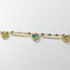 SVORA gold-plated stainless steel layered chain bracelet with green and blue heart-shaped cubic zirconia stones.