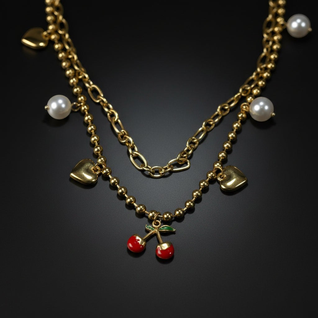 SVORA gold layered necklace with paperclip and ball-bead chains, featuring pearl, heart, and cherry charms.