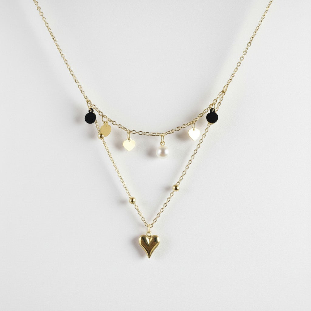 SVORA gold layered necklace with heart, disc, and pearl charms. Stainless steel, 18k gold plated.