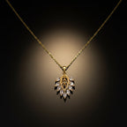 SVORA gold leaf cluster pendant with marquise CZ stones and a delicate chain. Botanical and modern design.