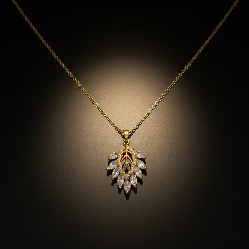 SVORA gold leaf cluster pendant with marquise CZ stones and a delicate chain. Botanical and modern design.