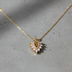 SVORA gold leaf cluster pendant with marquise CZ stones on a delicate chain. Botanical, ornate, modern design.