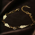 SVORA gold figaro chain bracelet with leaf-shaped links, adjustable lobster clasp, 18K gold plated stainless steel.
