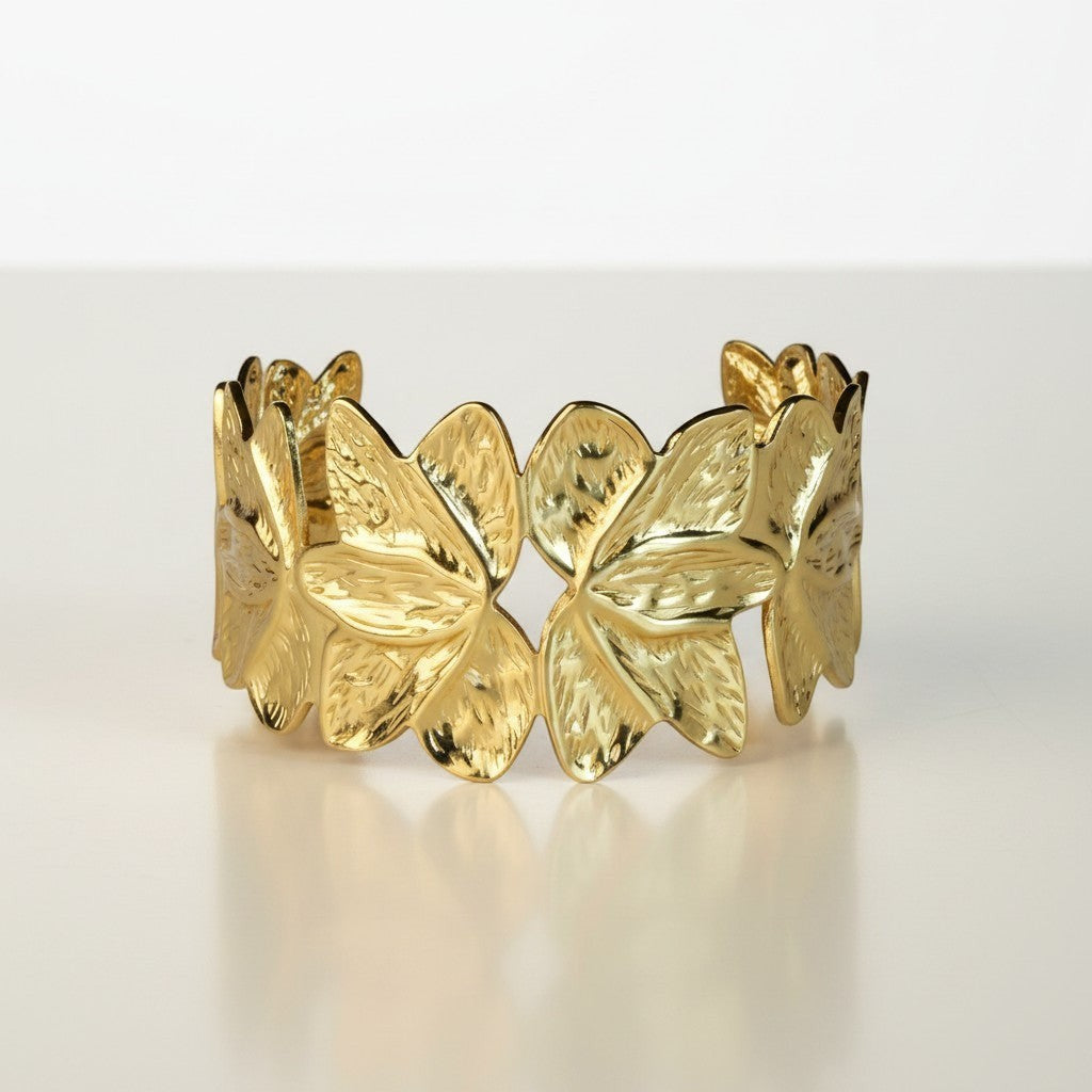 SVORA gold lotus open cuff bracelet made of 18K gold plated stainless steel with textured petals.