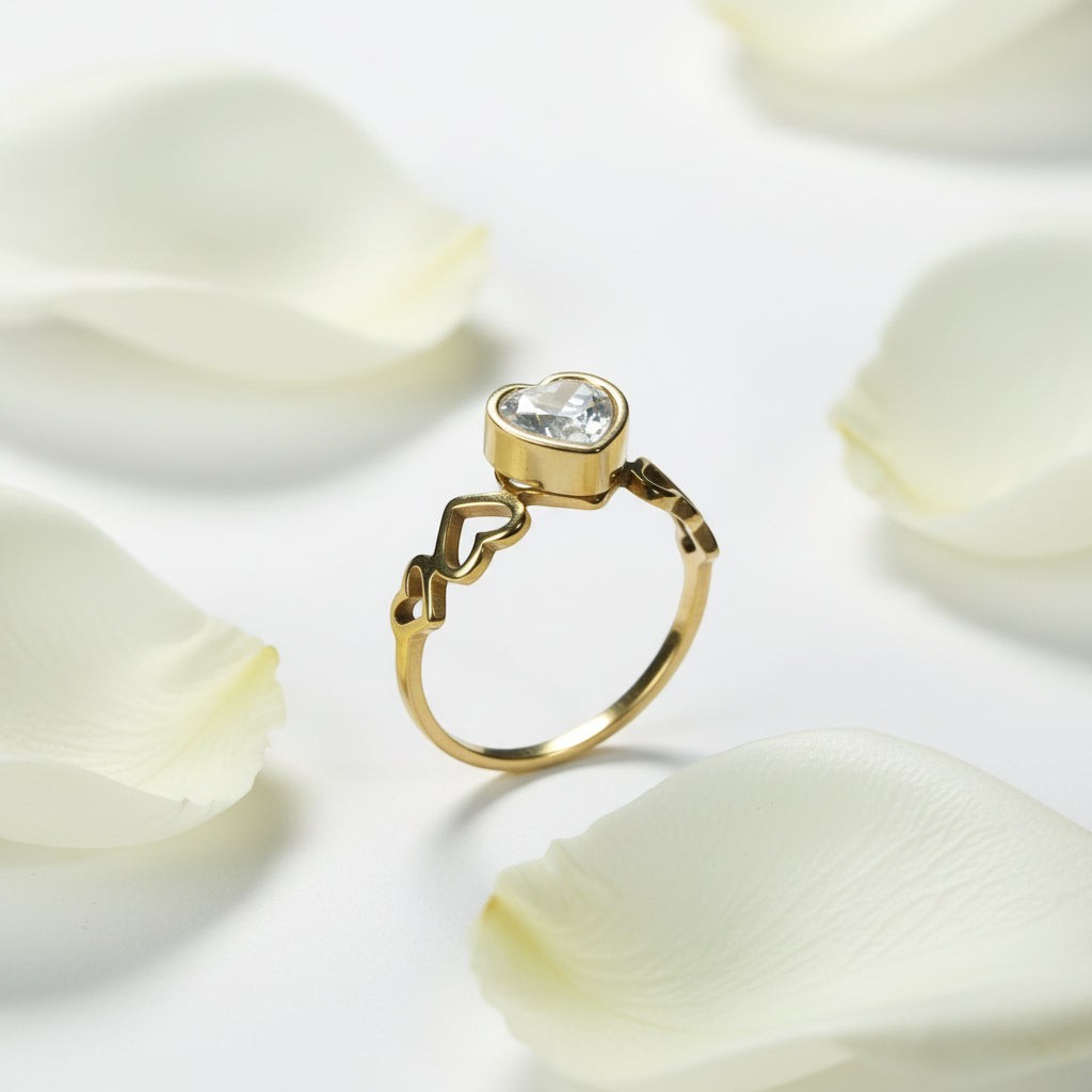 SVORA Lumiere Amour gold heart ring with clear stone, featuring open heart details on the band. 18K gold plated.