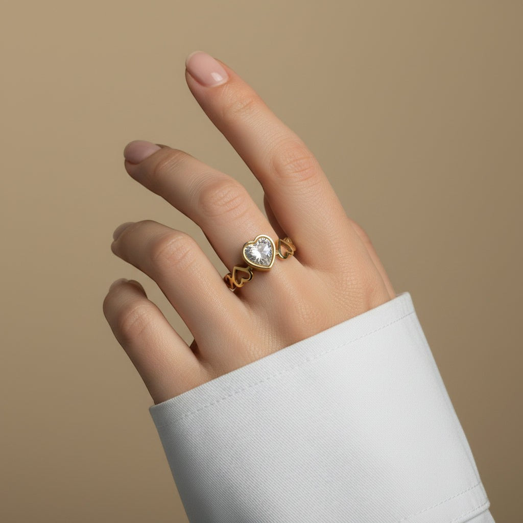 SVORA Lumiere Amour Heart Ring with a bezel-set heart-cut stone and open heart details on the band, 18K gold plated.